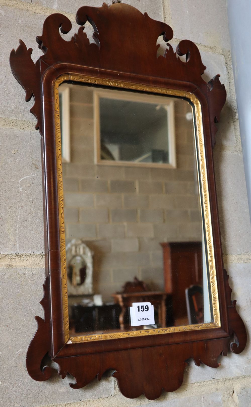 A small George III style mahogany fret cut wall mirror, width 40cm, height 70cm